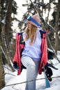 Close up portrait of snowboarder woman at ski resort wearing helmet and goggles with reflection of mountains. Free copy Royalty Free Stock Photo