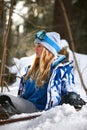 Close up portrait of snowboarder woman at ski resort wearing helmet and goggles with reflection of mountains. Free copy Royalty Free Stock Photo