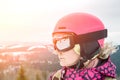 Close up portrait of snowboarder woman at ski resort wearing helmet and goggles with reflection of mountains. Sun flare Royalty Free Stock Photo