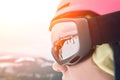 Close up portrait of snowboarder woman at ski resort wearing helmet and goggles with reflection of mountains. Sun flare Royalty Free Stock Photo