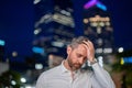 Close up portrait of stressed business man on night city background. Stressed ceo manager have stress and headache Royalty Free Stock Photo