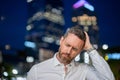 Close up portrait of stressed business man on night city background. Stressed ceo manager have stress and headache Royalty Free Stock Photo