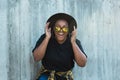 Close-up portrait of stylish funny African American girl with curly hair in fashionable sunglasses in urban - summer Royalty Free Stock Photo