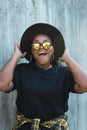 Close-up portrait of stylish funny African American girl with curly hair in fashionable sunglasses in urban - summer Royalty Free Stock Photo