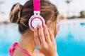 Close-up portrait of stylish girl with cute hairstyle resting in the outdoor blue pool in sunny day. Tanned young woman Royalty Free Stock Photo