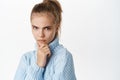 Close up portrait of stylish little teen girl, looking serious and thoughtful, thinking or making decision, express Royalty Free Stock Photo