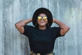 Close-up portrait of stylish young African American girl with curly hair in fashionable sunglasses in urban - summer Royalty Free Stock Photo