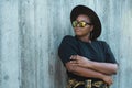 Close-up portrait stylish young African American girl with curly hair in fashionable sunglasses in urban with copy space Royalty Free Stock Photo