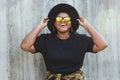 Close-up portrait of stylish young African American girl with curly hair in fashionable sunglasses in urban - summer Royalty Free Stock Photo