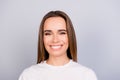 Close up portrait of successful young brown haired lady entrepreneur in white casual t shirt, standing on the pure light grey Royalty Free Stock Photo