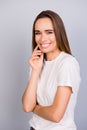 Close up portrait of successful young lady in white casual tshirt, standing on the pure light grey background, adorable, charming Royalty Free Stock Photo