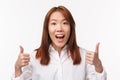 Close-up portrait of supportive cute asian positive girl show thumbs-up and smiling amused, express excitement and