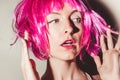 Close-up portrait of surprised young sexy woman in pink bob cut wig, bright rose lips makeup. Vibrant color. People naturally look Royalty Free Stock Photo