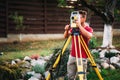 Portrait of survey engineer using and working with total station theodolite at landscaping project Royalty Free Stock Photo
