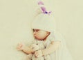 Portrait of sweet baby sleeping with teddy bear toy on a white bed at home Royalty Free Stock Photo