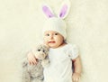 Close up portrait of sweet baby sleeping with teddy bear toy on a white bed Royalty Free Stock Photo