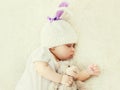 Close up portrait of sweet baby sleeping with teddy bear toy on a white bed Royalty Free Stock Photo