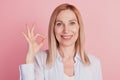 Close up portrait of sweet cute girl gesturing ok sign with fingers deal done alright isolated on pink background