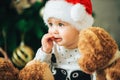 Close up portrait of sweet little baby in christmas hat Royalty Free Stock Photo