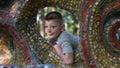 Close up portrait of teen boy. Funny cute teenager looking through a hole Royalty Free Stock Photo