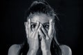 Close up portrait terrified young attractive latin woman looking frightened through her fingers in facial expressions and human