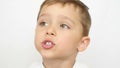 Close-up: portrait of a thoughtful child. The boy looks thoughtfully, then says something