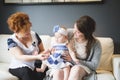 Close up portrait of three generations of women being close, grandmother, mother and baby daughter at home Royalty Free Stock Photo
