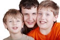 Close-up portrait of three grinning boys