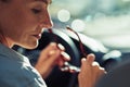 Close up portrait of tired middle aged business woman taking off eyeglasses while sitting behind steering wheel of her Royalty Free Stock Photo