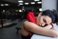 Close-up portrait of tired young beautful fitness woman leaning to sill in the gym after cardio. Sportswoman taking a break from Royalty Free Stock Photo