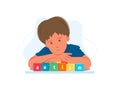 Close up portrait of toddler autistic boy with word AUTISM on wooden blocks