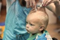 Close up portrait of toddler child getting his first haircut