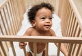 Close up portrait of a toddler in a crib.