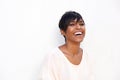 Close up trendy young black lady laughing against white background Royalty Free Stock Photo