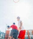 Close up portrait of two basketball players while the push each other for ball possession Royalty Free Stock Photo