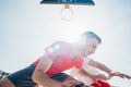 Close up portrait of two basketball players while the push each other for ball possession Royalty Free Stock Photo