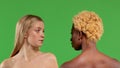 Close-up portrait of two beautiful young blonde and dark-skinned women, one woman standing facing the camera and the Royalty Free Stock Photo