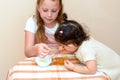 Jewish children dipping apple slices into honey on Rosh HaShanah. Royalty Free Stock Photo