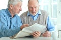 Close up portrait of two senior men sitting at table Royalty Free Stock Photo