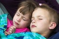 Close-up portrait of two small adorable cute blond children, brother and sister, boy and girl soundly sleeping under colorful blan Royalty Free Stock Photo