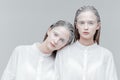 Close-up portrait of two women in smart white shirts