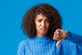 Close-up portrait unsatisfied, gloomy sad, sulking african american girl with pouting lips showing thumb-down Royalty Free Stock Photo