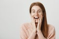 Close-up portrait of upbeat redhead girl with cute freckles, touching face with both hands and smiling broadly Royalty Free Stock Photo