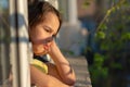 Close up of portrait upset little girl look far in window thinking about troubles, sad child