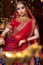 Close up Portrait of very beautiful indian Bride in bridal costume with makeup and stone jewellery Royalty Free Stock Photo