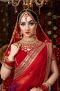 Close up Portrait of very beautiful indian Bride in bridal costume with makeup and stone jewellery Royalty Free Stock Photo