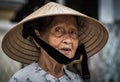 Close up Portrait of an Vietnamese old woman wearing traditional conical hat