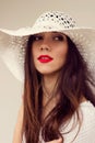 Close-up portrait. White straw hat. Sensual red lips. Boho style
