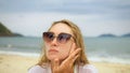 Close-up portrait woman apply sun cream protection lotion. Young woman on beach near sea applying sunscreen. Pretty Royalty Free Stock Photo