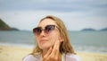 Close-up portrait woman apply sun cream protection lotion. Young woman on beach near sea applying sunscreen. Pretty Royalty Free Stock Photo